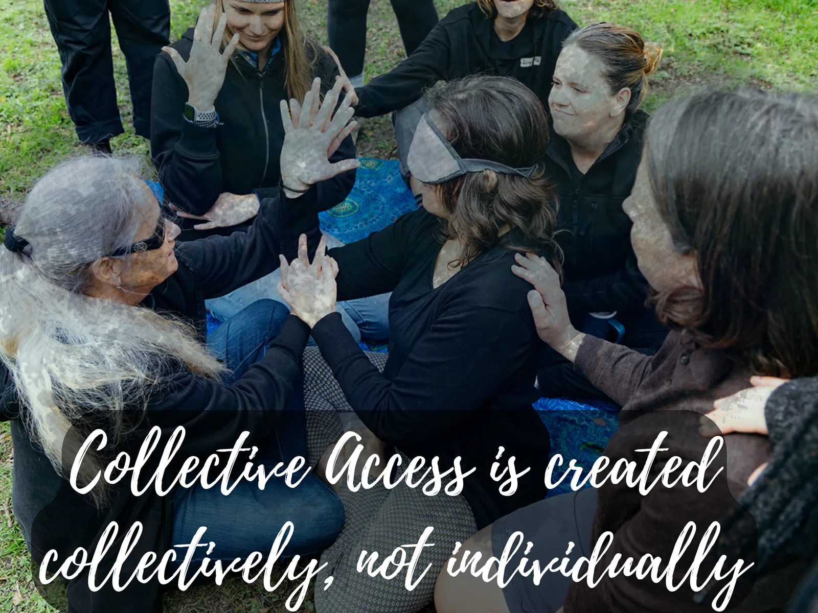 A group sits close together on the grass, hands touching; one person wears a blindfold. Text: “Collective Access is created collectively, not individually.”