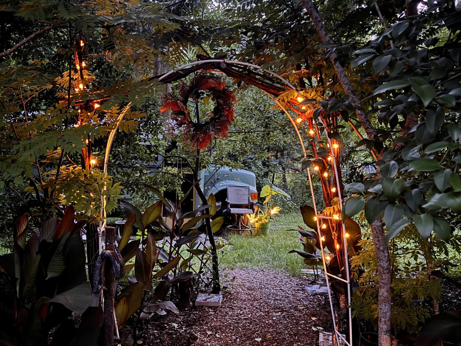 An lighted arch shows a Skoolie bus.